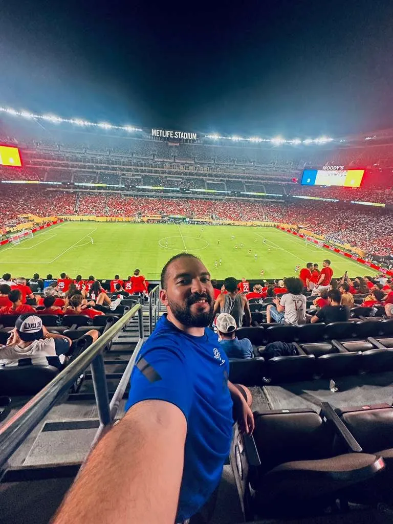 Nour at a football stadium at night